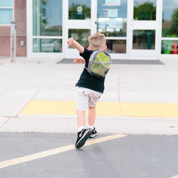 Image of boy running to school